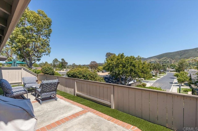 view of patio / terrace featuring a fenced backyard and a mountain view