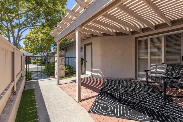 view of patio featuring fence, a gate, and a pergola