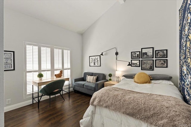 bedroom with dark wood finished floors, multiple windows, baseboards, and high vaulted ceiling