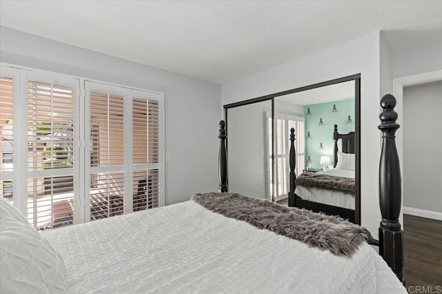 bedroom featuring multiple windows, dark wood finished floors, and baseboards