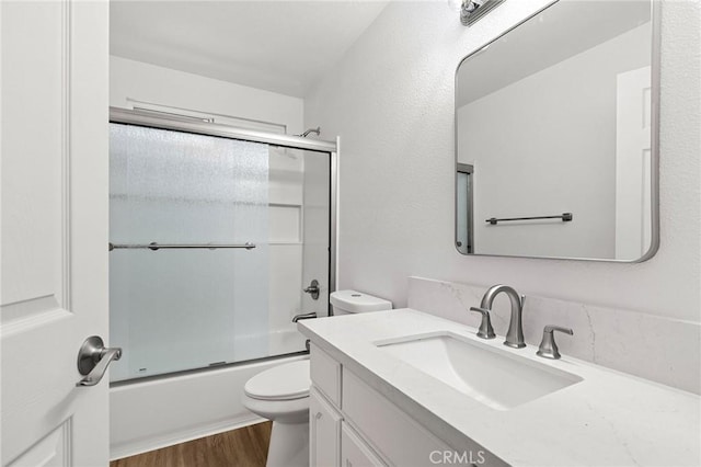 6175 Showdown Cir, Magalia, CA 95954 - full bathroom with toilet, vanity, wood finished floors, and combined bath / shower with glass door