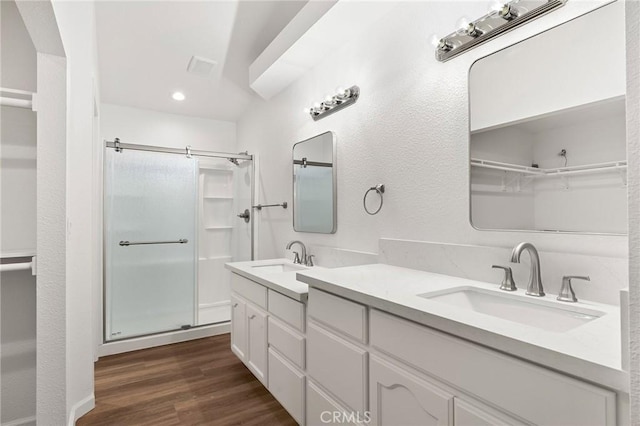 6175 Showdown Cir, Magalia, CA 95954 - full bathroom featuring a stall shower, wood finished floors, double vanity, and recessed lighting