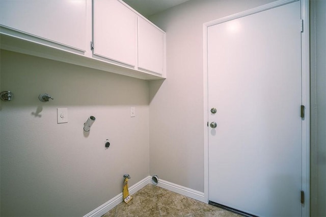 laundry area featuring hookup for a gas dryer, baseboards, hookup for an electric dryer, and cabinet space