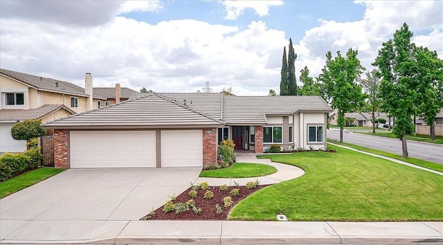 view of front of home featuring brick siding, driveway, an attached garage, a front lawn, and a tile roof