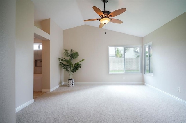 unfurnished room featuring carpet floors, ceiling fan, baseboards, and lofted ceiling