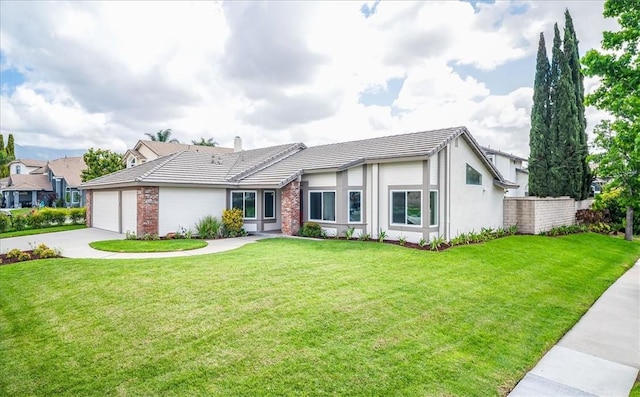 view of front of property featuring concrete driveway, a garage, a chimney, a front yard, and a tile roof