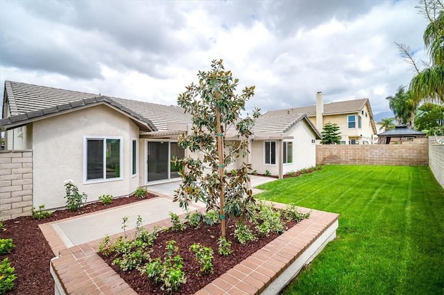 rear view of house featuring stucco siding, a tile roof, and a patio area