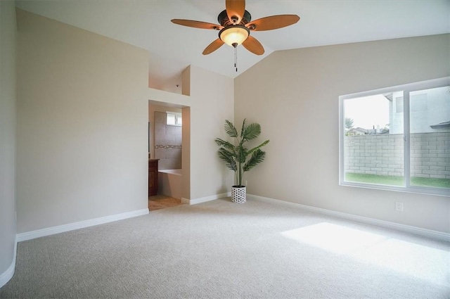 empty room featuring carpet floors, vaulted ceiling, ceiling fan, and baseboards