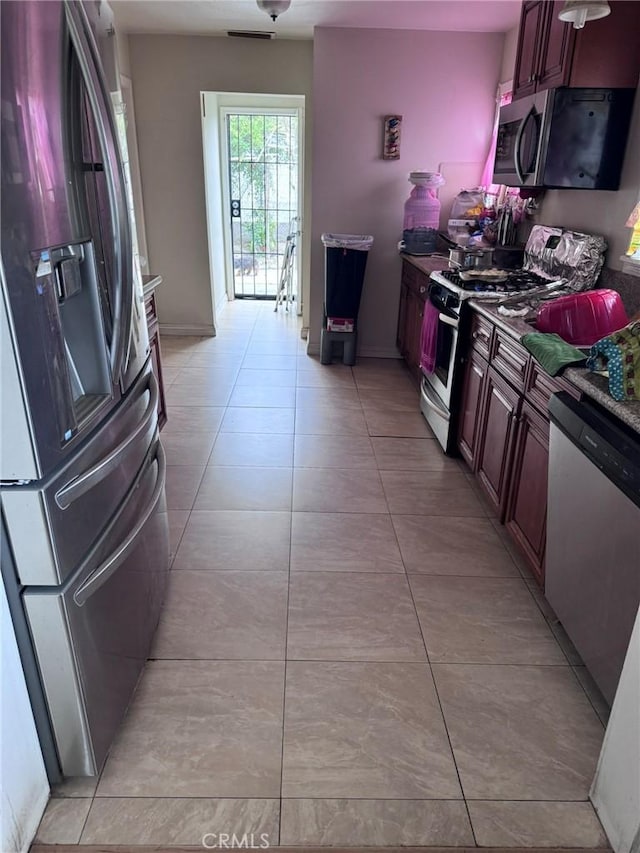 7881 Franklin St, Buena Park, CA 90621 - kitchen with appliances with stainless steel finishes, baseboards, and light tile patterned floors