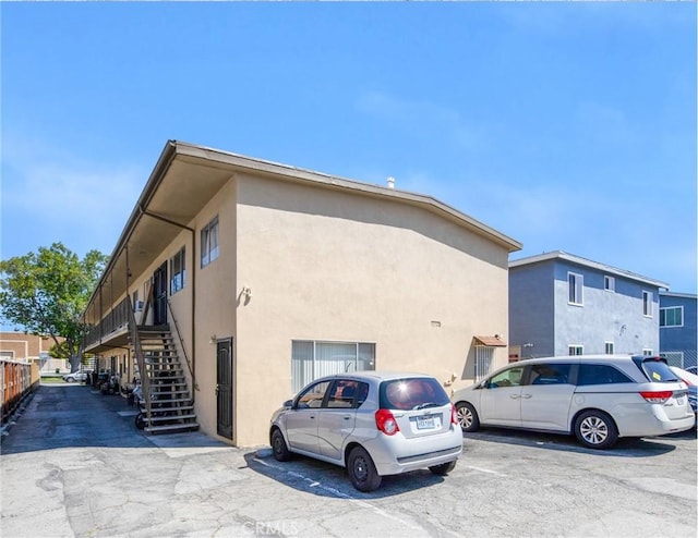1344 W 225th St, Torrance, CA 90501 - view of home's exterior with stairs, stucco siding, and uncovered parking