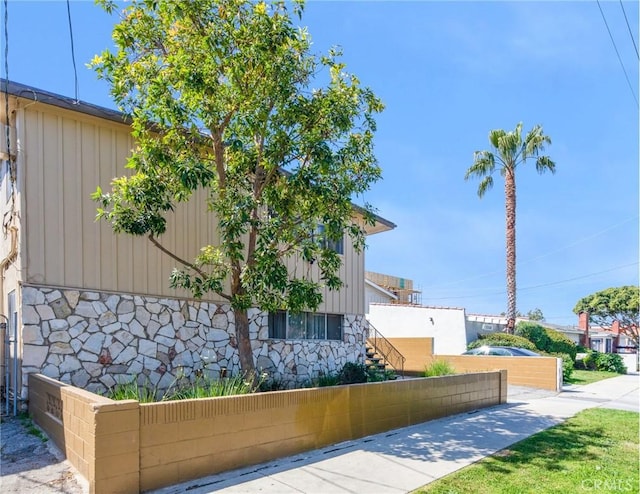 1344 W 225th St, Torrance, CA 90501 - view of home's exterior featuring board and batten siding and stone siding