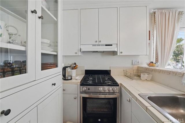 1 Jib St Unit 103, Marina Del Rey, CA 90292 - kitchen featuring stainless steel range with gas cooktop, under cabinet range hood, white cabinets, and tile counters