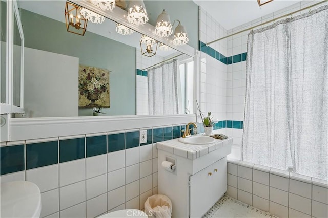 1 Jib St Unit 103, Marina Del Rey, CA 90292 - full bath featuring toilet, tiled shower / bath combo, a chandelier, vanity, and tile walls