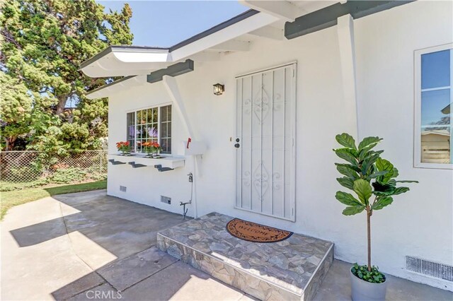 10612 Ketch Ave, Garden Grove, CA 92843 - view of exterior entry with stucco siding, crawl space, and a patio area