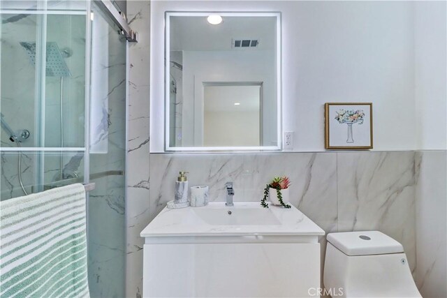 10612 Ketch Ave, Garden Grove, CA 92843 - full bath with a marble finish shower, vanity, and tile walls