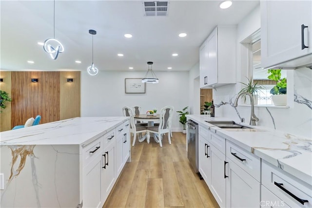 10612 Ketch Ave, Garden Grove, CA 92843 - kitchen featuring stainless steel dishwasher, recessed lighting, light wood-style floors, white cabinets, and pendant lighting
