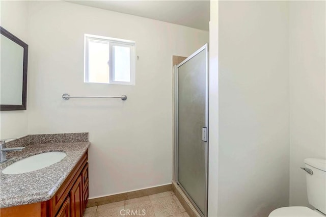 1720 W 25th St, Los Angeles, CA 90018 - full bathroom with a shower stall, toilet, vanity, baseboards, and tile patterned floors