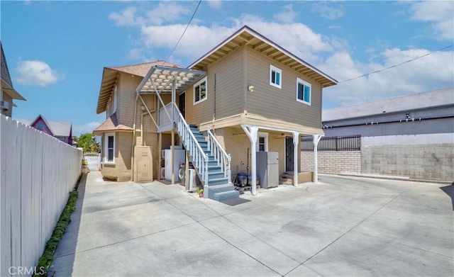 1720 W 25th St, Los Angeles, CA 90018 - view of front of house with stairway, stucco siding, a patio, and a fenced backyard