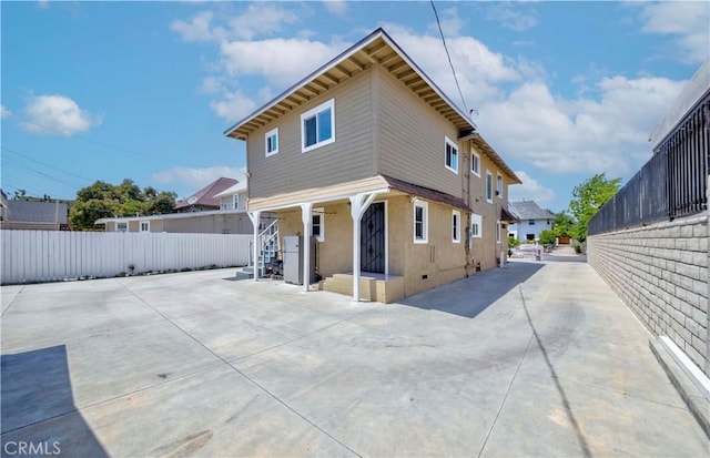 1720 W 25th St, Los Angeles, CA 90018 - back of property with fence, stucco siding, stairway, and a residential view