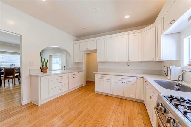 1720 W 25th St, Los Angeles, CA 90018 - kitchen with white cabinetry, light wood-style floors, healthy amount of natural light, and recessed lighting