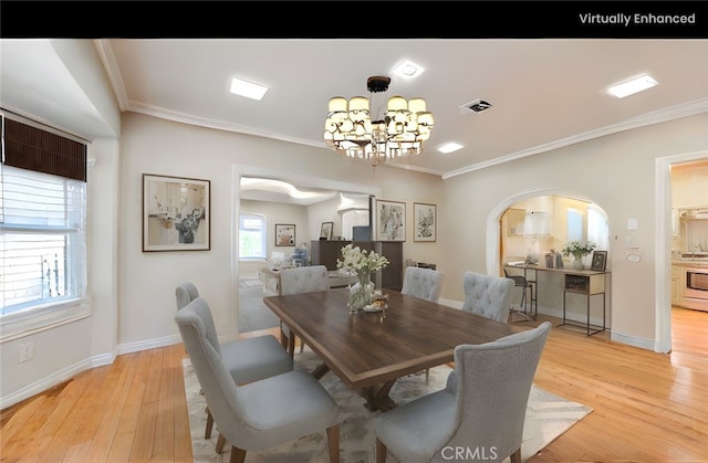 1720 W 25th St, Los Angeles, CA 90018 - dining space with arched walkways, crown molding, light wood-style floors, a chandelier, and baseboards