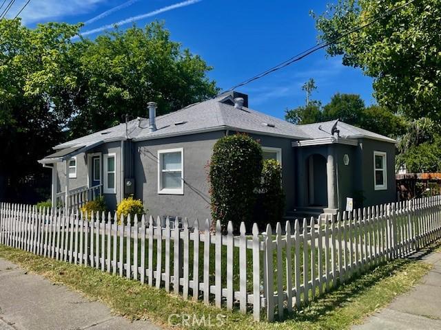 1201 S St, Corning, CA 96021 - view of front of property featuring stucco siding and a fenced front yard