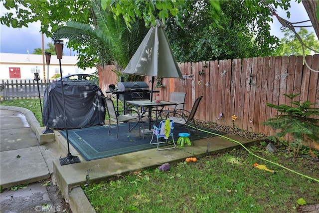 1201 S St, Corning, CA 96021 - fenced backyard featuring a grill and outdoor dining space