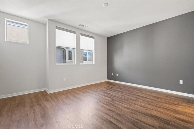 19505 Empire Ln, Northridge, CA 91324 - spare room featuring healthy amount of natural light, dark wood-style floors, and baseboards