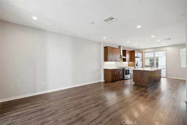 19505 Empire Ln, Northridge, CA 91324 - kitchen with stainless steel appliances, dark wood-style floors, light countertops, a kitchen island, and wall chimney range hood
