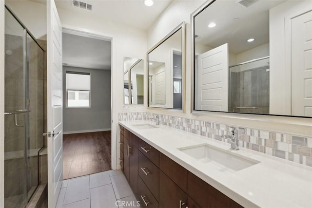 19505 Empire Ln, Northridge, CA 91324 - bathroom featuring a stall shower, double vanity, baseboards, and recessed lighting