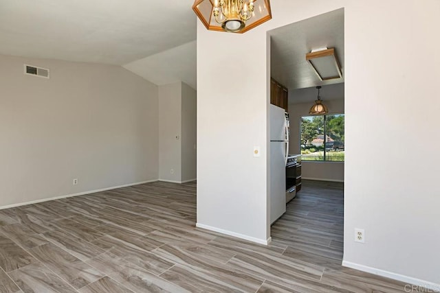 4616 Arrowhead Ct, Oceanside, CA 92056 - empty room with wood finished floors, baseboards, a chandelier, and vaulted ceiling
