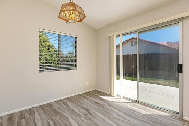 4616 Arrowhead Ct, Oceanside, CA 92056 - unfurnished room featuring a chandelier, vaulted ceiling, healthy amount of natural light, baseboards, and wood finished floors