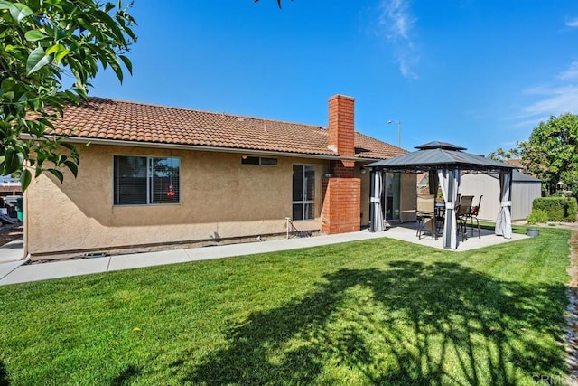4616 Arrowhead Ct, Oceanside, CA 92056 - back of house featuring a gazebo, stucco siding, a patio, a chimney, and a yard