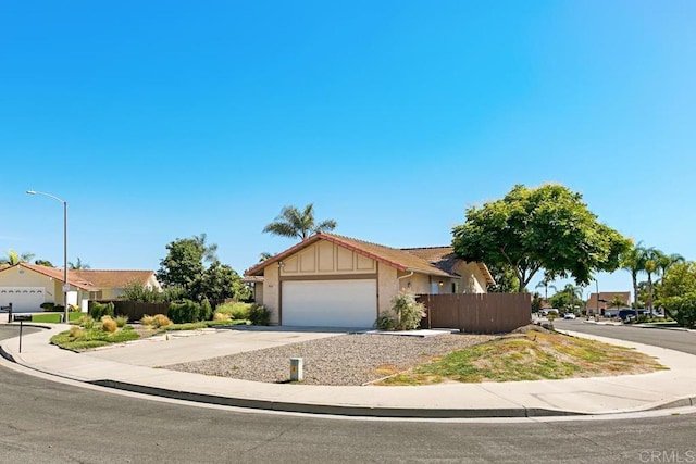 4616 Arrowhead Ct, Oceanside, CA 92056 - view of front facade featuring an attached garage, driveway, a tiled roof, stucco siding, and a residential view