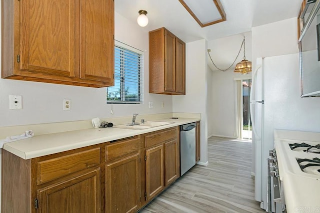 4616 Arrowhead Ct, Oceanside, CA 92056 - kitchen with stainless steel dishwasher, a sink, brown cabinetry, baseboards, and light countertops