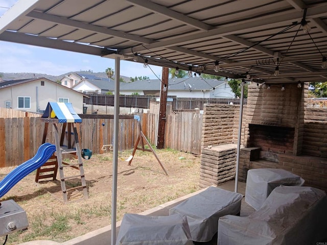 668 Farview St, El Cajon, CA 92021 - fenced backyard with an outdoor brick fireplace and a playground