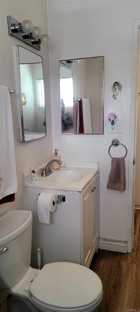 668 Farview St, El Cajon, CA 92021 - half bathroom with toilet, wood finished floors, and vanity