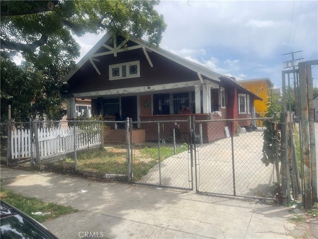 260 W 42nd Pl, Los Angeles, CA 90037 - view of front of house featuring covered porch, a fenced front yard, and a gate