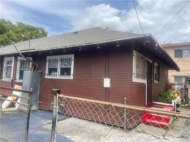 260 W 42nd Pl, Los Angeles, CA 90037 - view of home's exterior featuring roof with shingles