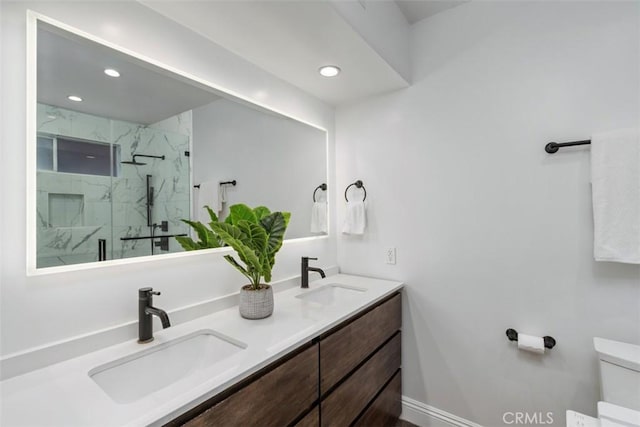 11575 Sunshine Ter, Studio City, CA 91604 - full bath with a marble finish shower, toilet, recessed lighting, double vanity, and baseboards