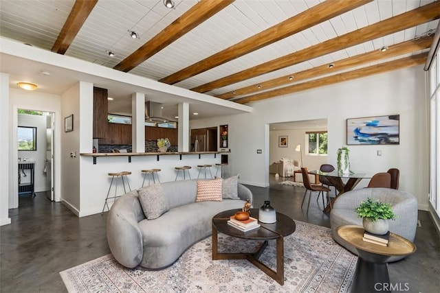11575 Sunshine Ter, Studio City, CA 91604 - living room with baseboards, finished concrete floors, beamed ceiling, healthy amount of natural light, and wooden ceiling