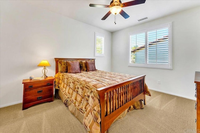 carpeted bedroom with baseboards and a ceiling fan