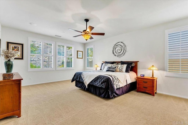 carpeted bedroom with baseboards and ceiling fan