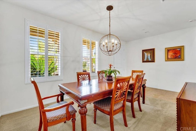 dining area featuring a chandelier and light carpet