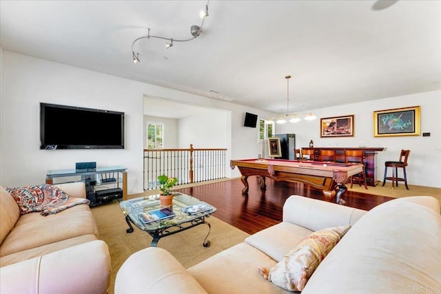 living area with wood finished floors and pool table