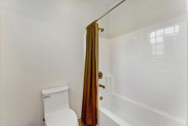 full bathroom with shower / bath combo with shower curtain and toilet