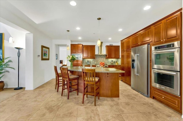 kitchen featuring stainless steel appliances, light countertops, a breakfast bar, brown cabinets, and decorative backsplash