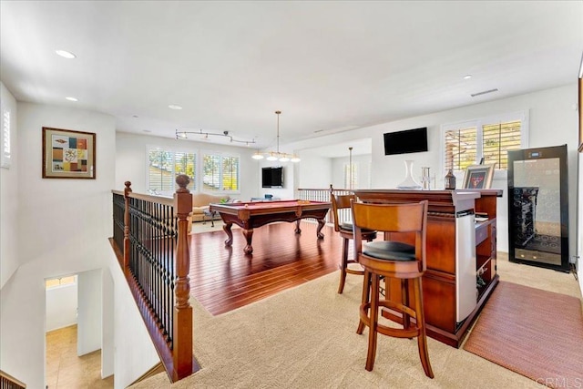 bar area featuring pool table, healthy amount of natural light, recessed lighting, light carpet, and beverage cooler