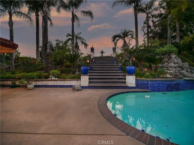 5338 Falling Tree Ln, Rancho Cucamonga, CA 91737 - pool at dusk with a patio area and an outdoor pool