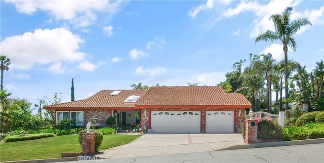 5338 Falling Tree Ln, Rancho Cucamonga, CA 91737 - view of front facade featuring a tile roof, an attached garage, a front yard, and driveway